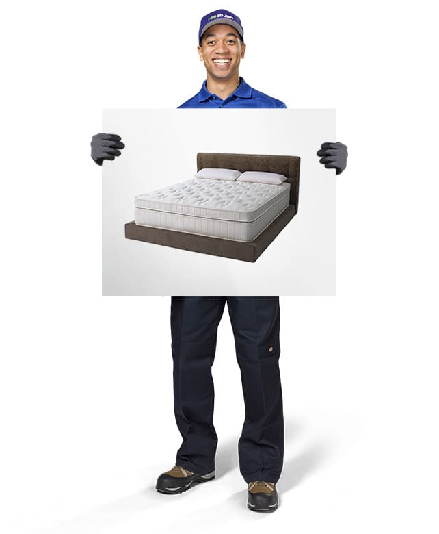 1-800-GOT-JUNK? Truck Team Member holding an image of a bed