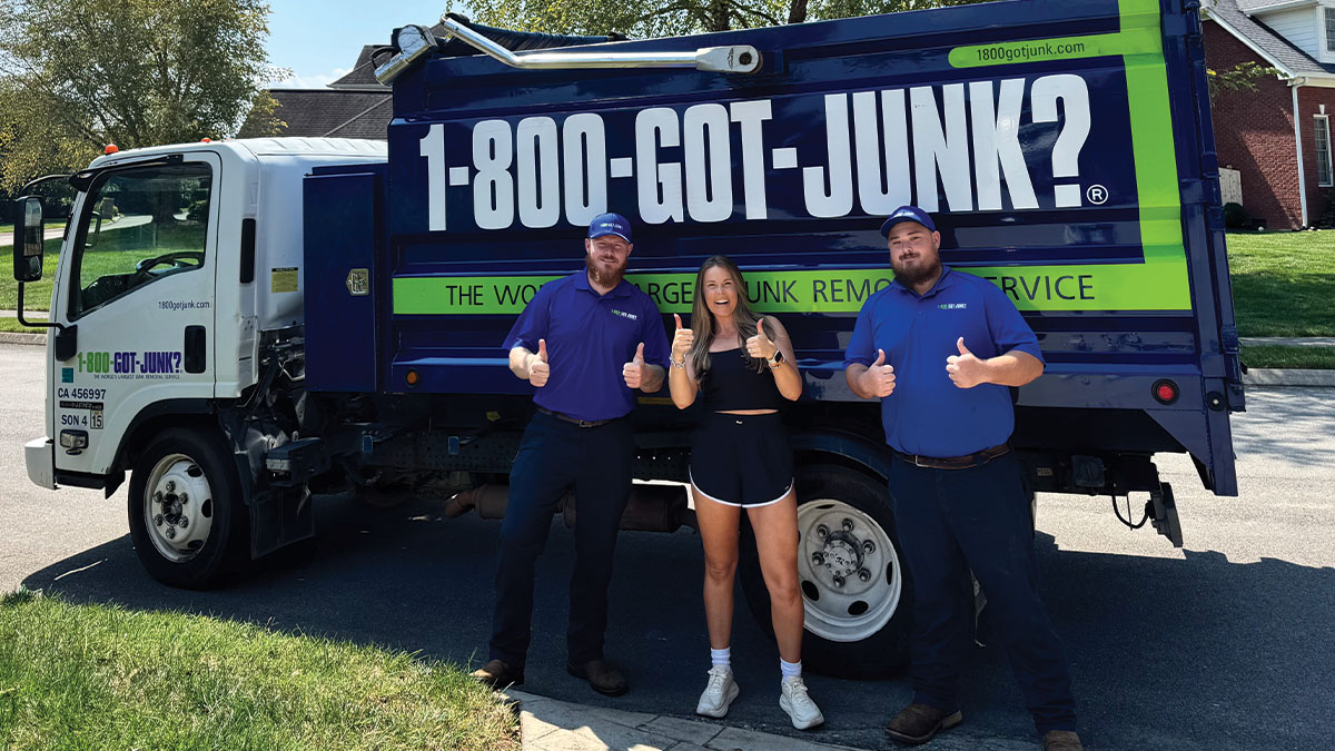Laura Elizabeth Graham with two 1-800-GOT-JUNK? Truck Team Members in front of a 1-800-GOT-JUNK?
