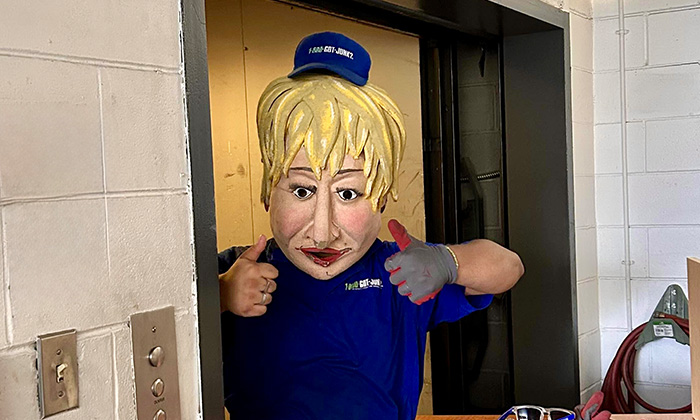 A 1-800-GOT-JUNK? Truck Team Member in a Papier-mache mask