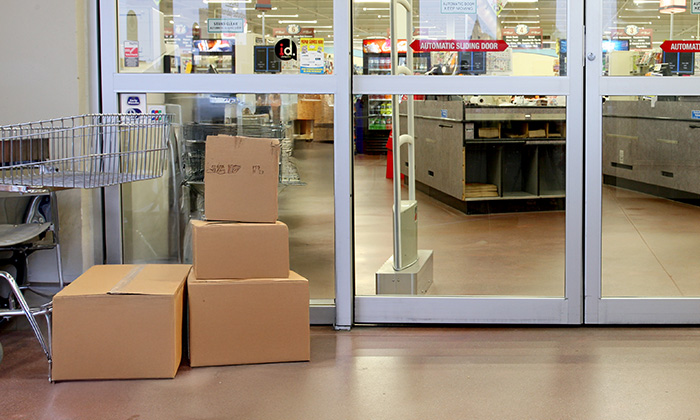 A pile of free cardboard boxes on the backside of a retail store.
