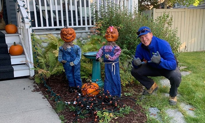 A 1-800-GOT-JUNK? Truck Team Member by two pumpkin heads