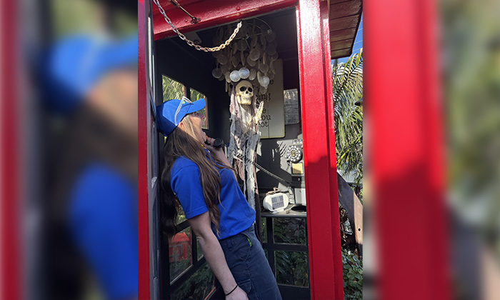 A 1-800-GOT-JUNK? Truck Team Member in a spooky phone booth.